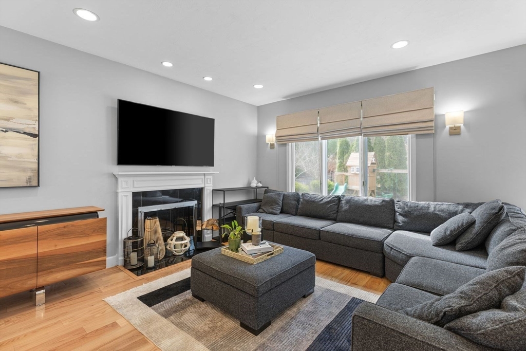 5 Sullivan Way Canton, MA 02021 - Photo 7 of 40 a living room with furniture a fireplace and a flat screen tv
