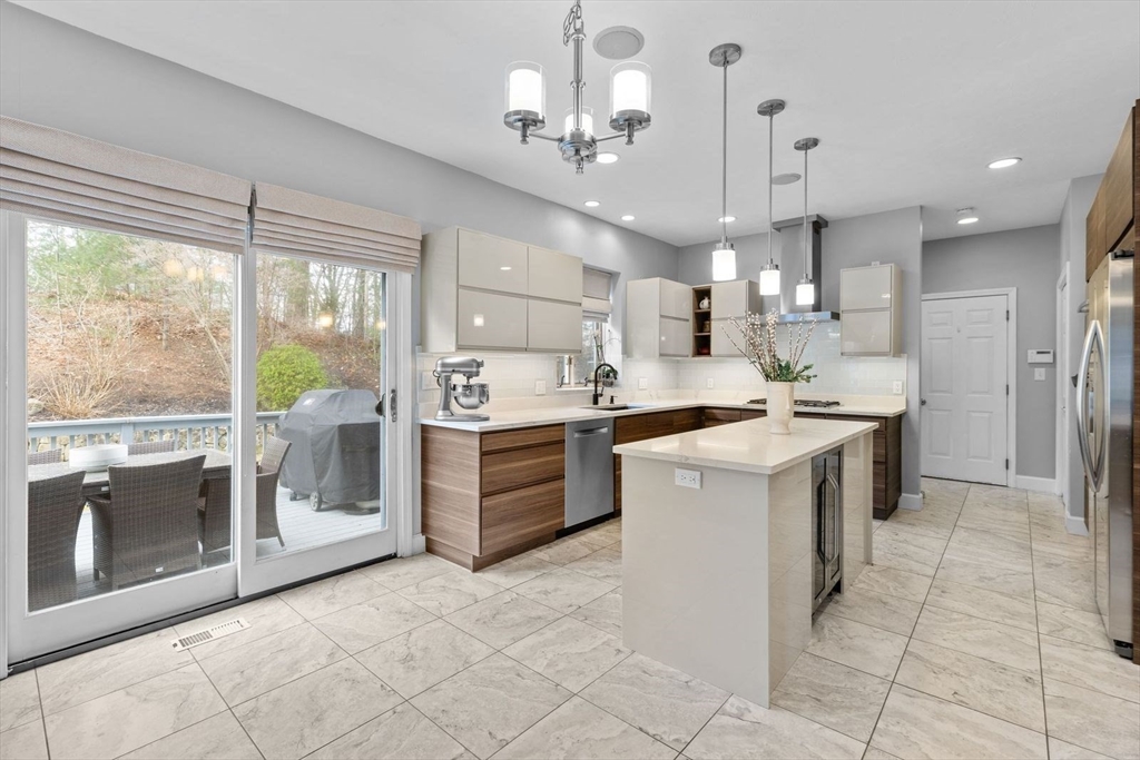 5 Sullivan Way Canton, MA 02021 - Photo 10 of 40 a kitchen with kitchen island granite countertop a sink counter top space appliances and a large window