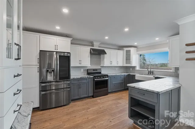 a kitchen with a sink stove and refrigerator