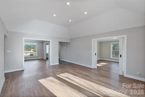 a view of a livingroom with wooden floor and a window