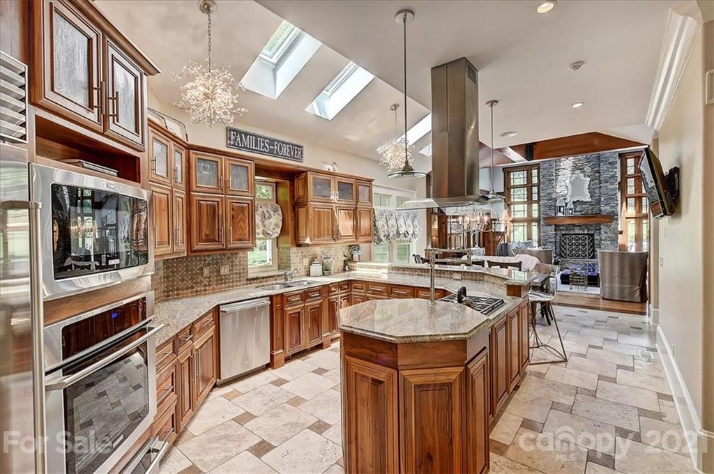 3211 Trinity Church Road Concord, NC 28027 - Photo 14 of 48 a kitchen with stainless steel appliances granite countertop a sink a stove and a refrigerator
