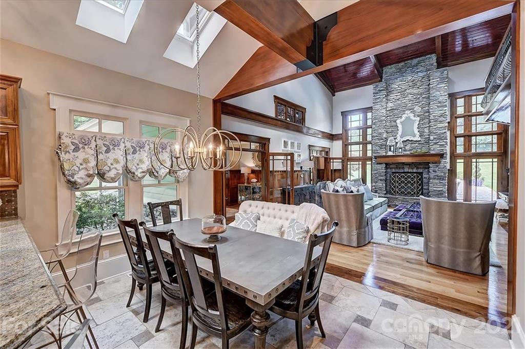 3211 Trinity Church Road Concord, NC 28027 - Photo 17 of 48 a dining room with furniture a fireplace and wooden floor