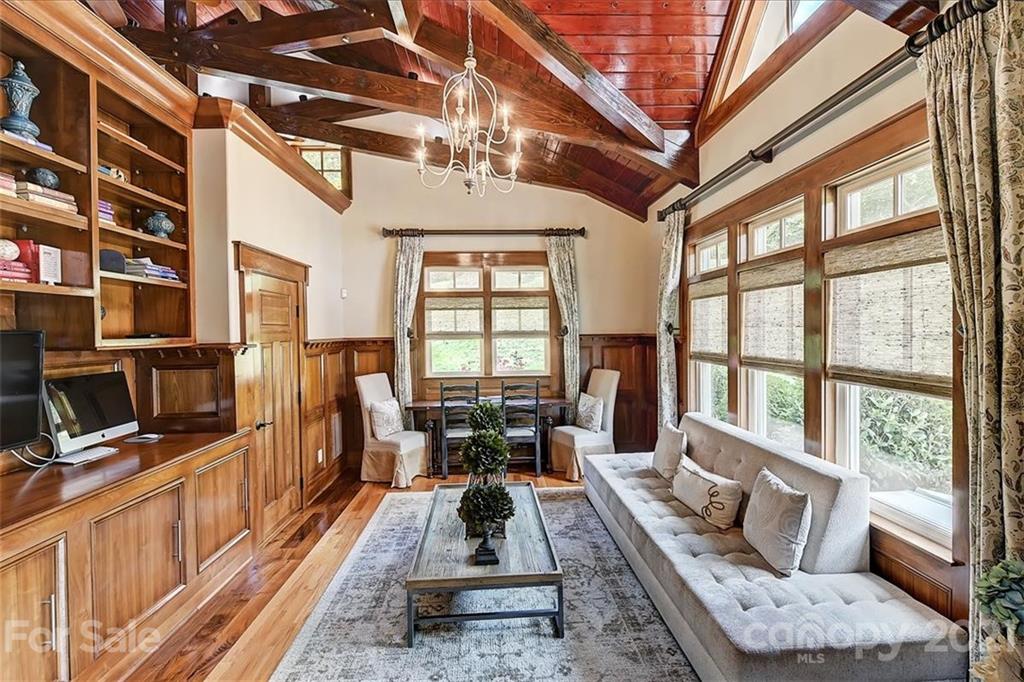 3211 Trinity Church Road Concord, NC 28027 - Photo 22 of 48 a living room with furniture a flat screen tv and a floor to ceiling window