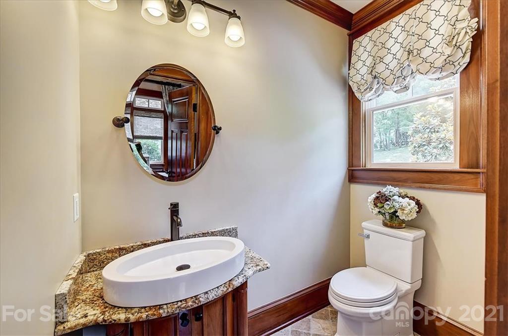 3211 Trinity Church Road Concord, NC 28027 - Photo 24 of 48 a bathroom with a toilet a sink and a mirror