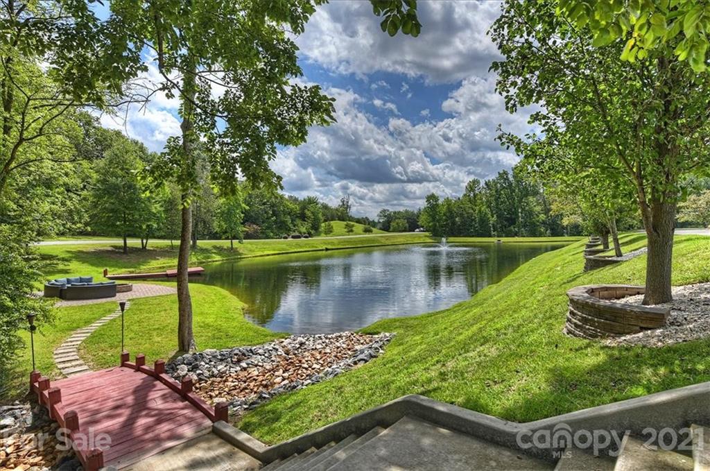 3211 Trinity Church Road Concord, NC 28027 - Photo 4 of 48 a view of a lake with a bench next to a lake