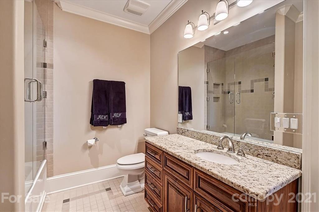 3211 Trinity Church Road Concord, NC 28027 - Photo 33 of 48 a bathroom with a granite countertop sink a toilet a mirror and shower