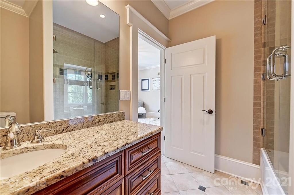 3211 Trinity Church Road Concord, NC 28027 - Photo 36 of 48 a bathroom with a granite countertop sink and a mirror
