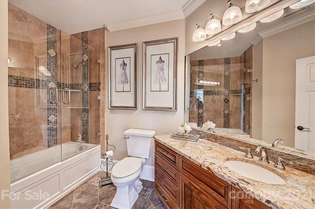 3211 Trinity Church Road Concord, NC 28027 - Photo 38 of 48 a bathroom with a granite countertop toilet sink and bathtub