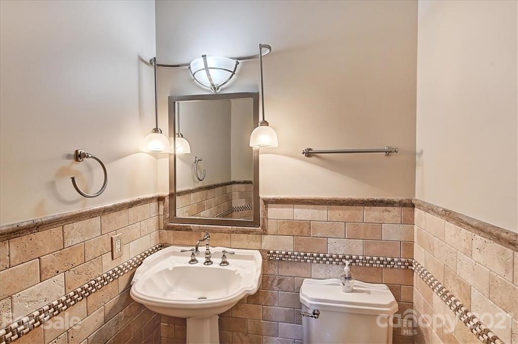 3211 Trinity Church Road Concord, NC 28027 - Photo 44 of 48 a bathroom with a sink a toilet and a mirror