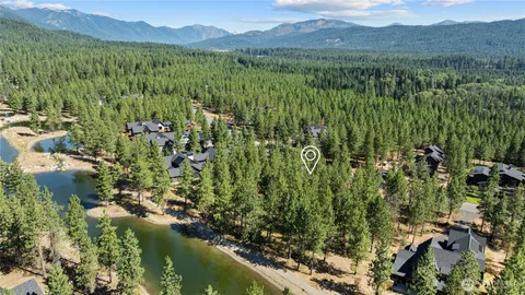 a view of a lake in front of residential houses with outdoor space