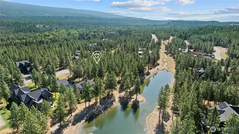 an aerial view of a residential houses with yard