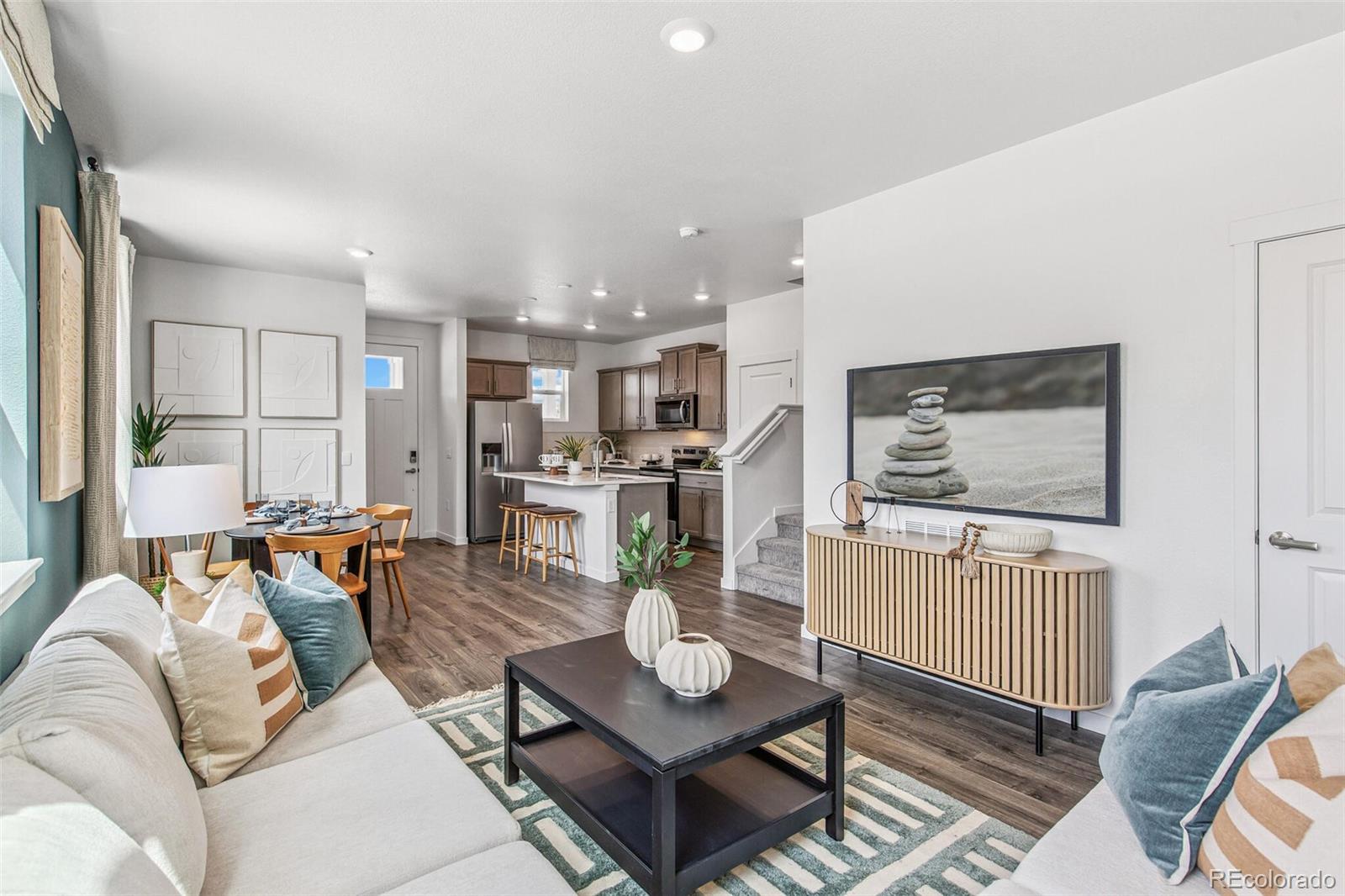 1389 South Chester Street, Unit A Denver, CO 80247 - Photo 3 of 30 a living room with furniture and a table