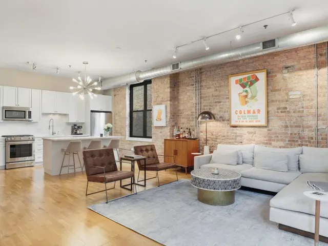 a living room with furniture and kitchen view
