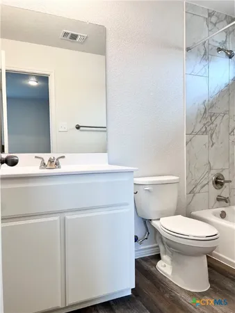 a bathroom with a sink toilet and mirror