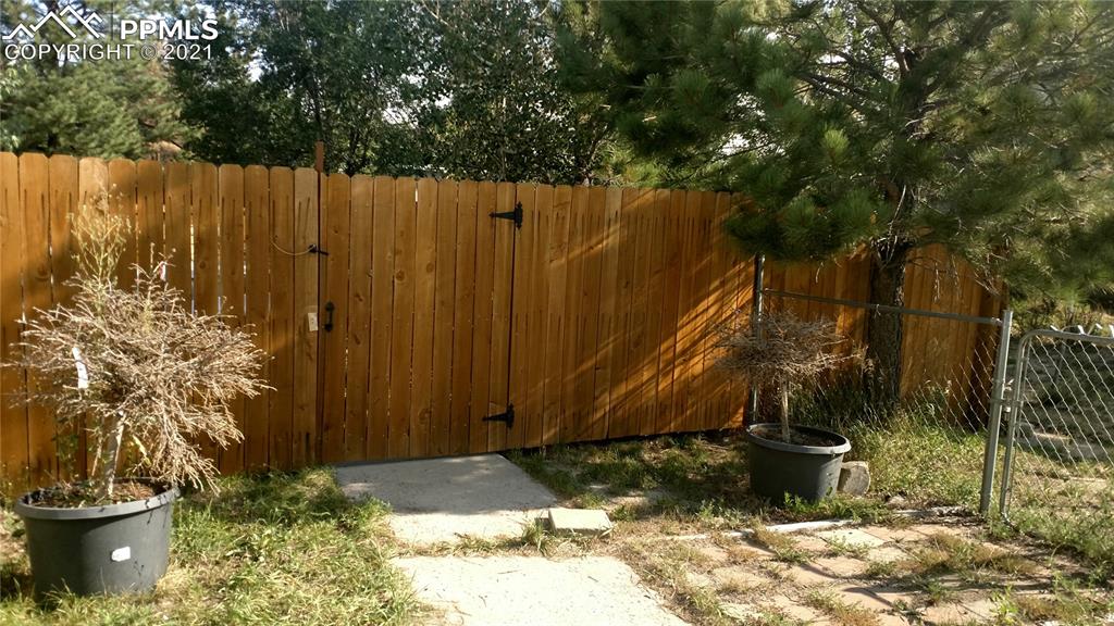 476 Elbert Street Elizabeth, CO 80107 - Photo 13 of 16 a view of a backyard with potted plants and large trees