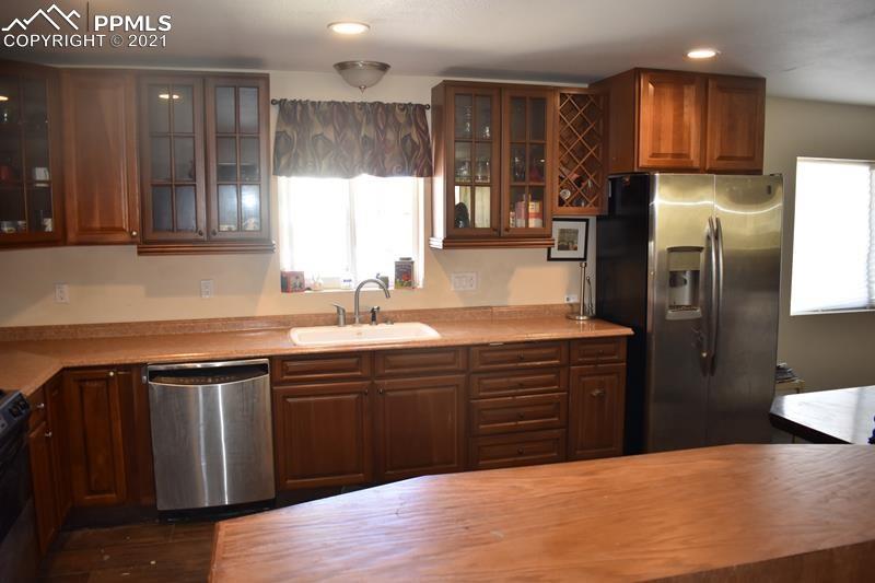 476 Elbert Street Elizabeth, CO 80107 - Photo 5 of 16 a kitchen with stainless steel appliances granite countertop a sink a stove a refrigerator and island