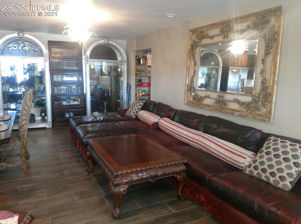 476 Elbert Street Elizabeth, CO 80107 - Photo 7 of 16 a living room filled with furniture and a chandelier