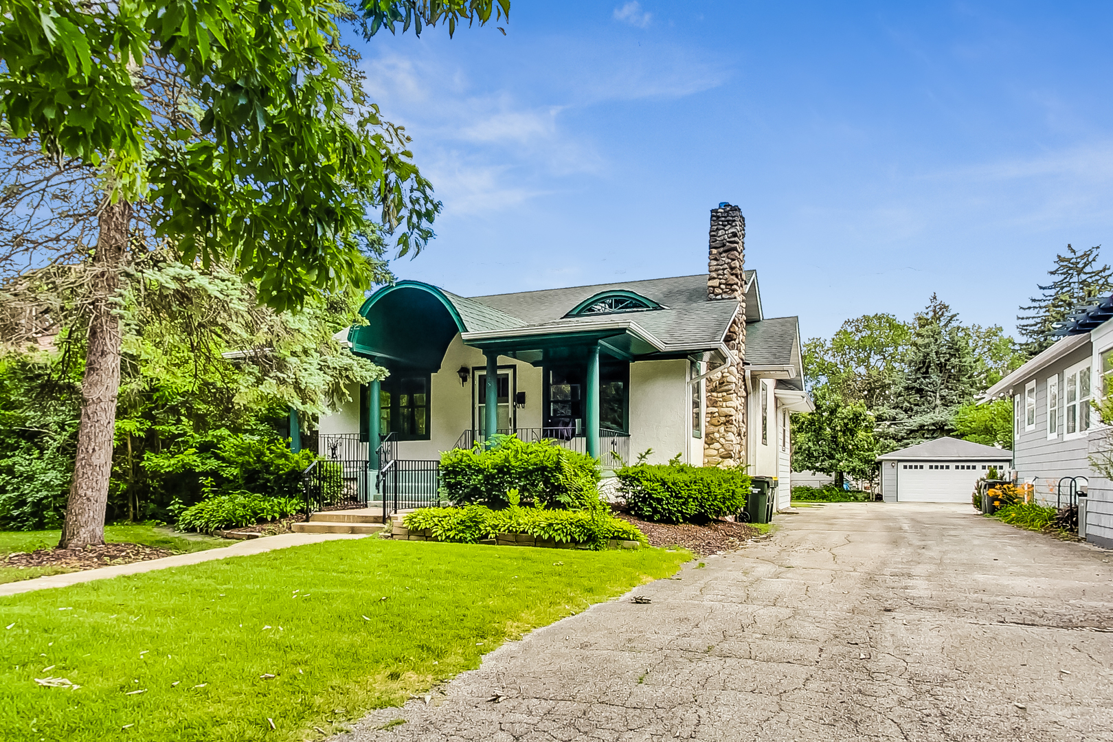 225 Herrick Road Riverside, IL 60546 - Photo 2 of 42 a front view of a house with garden