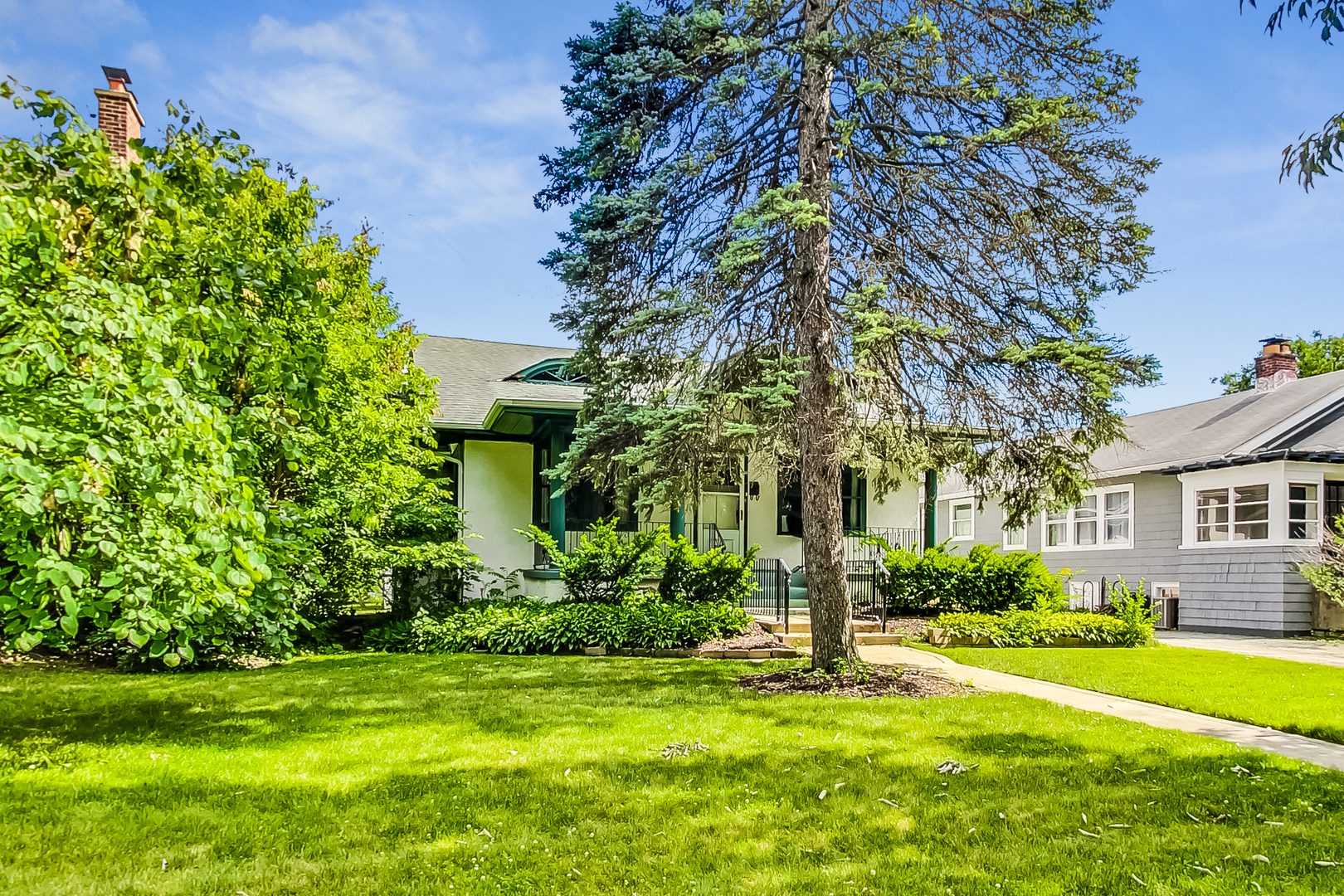 225 Herrick Road Riverside, IL 60546 - Photo 3 of 42 a garden with trees in front of it