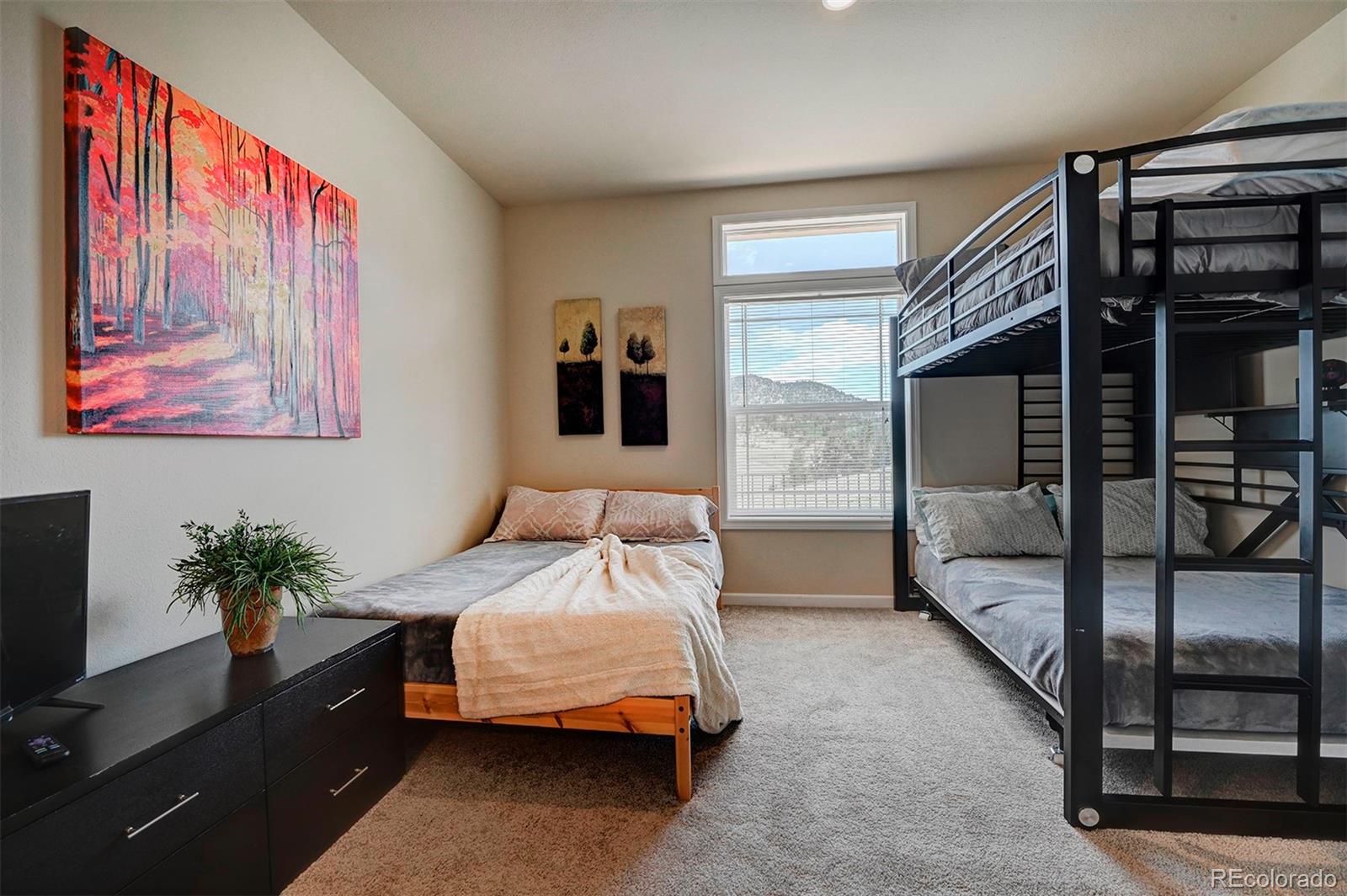 142 Long Rifle Way Como, CO 80432 - Photo 13 of 24 a bedroom with a bed and a painting on the wall