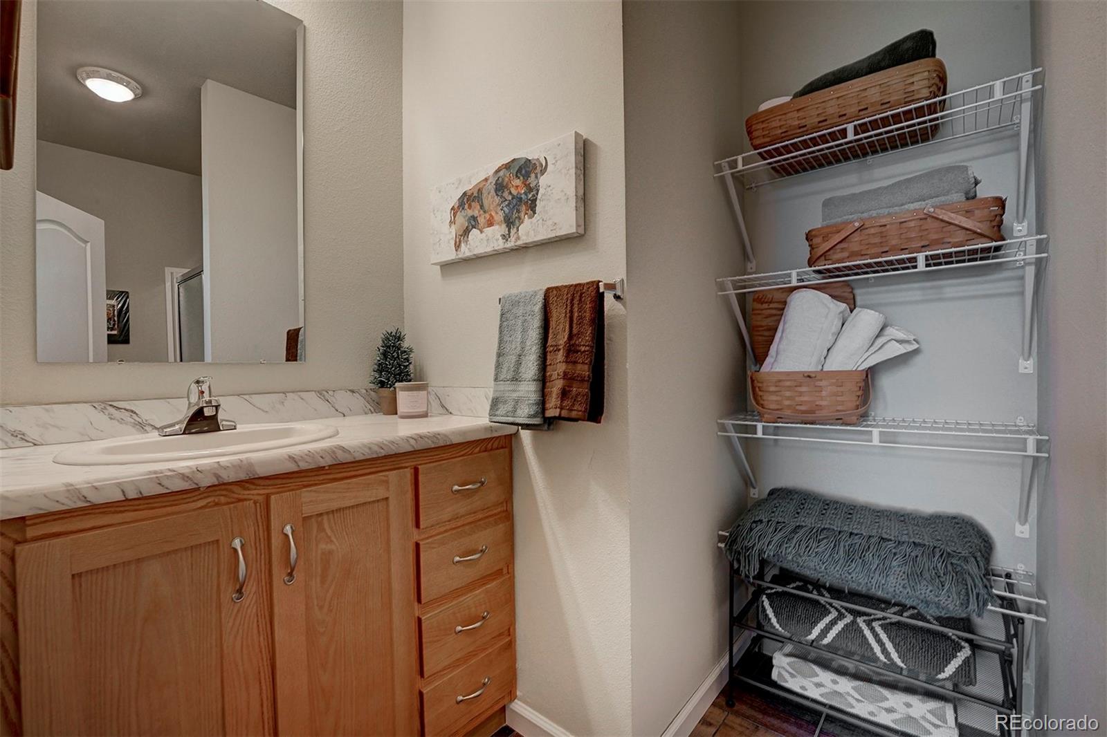 142 Long Rifle Way Como, CO 80432 - Photo 15 of 24 a bathroom with a sink and a mirror