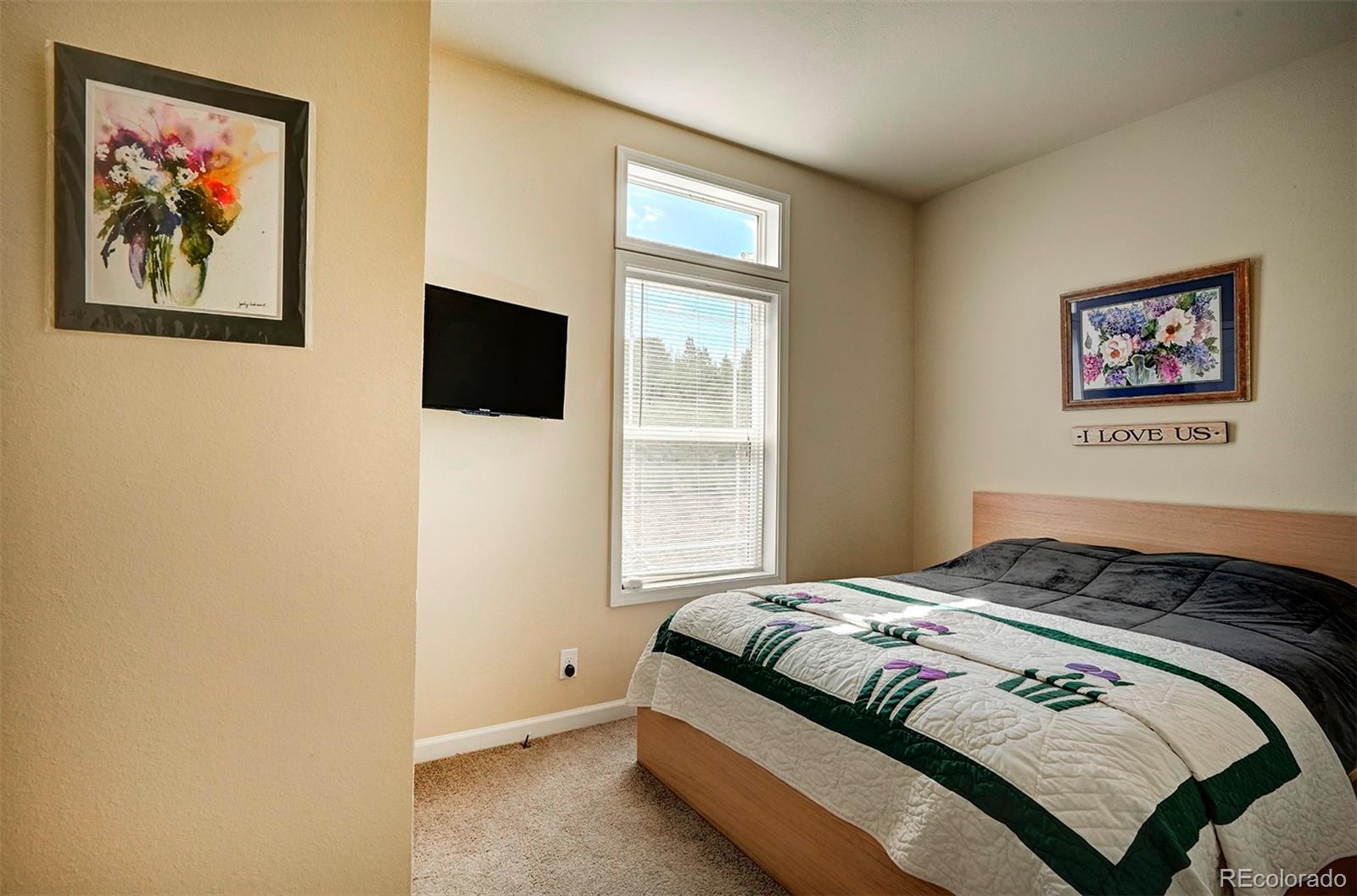 142 Long Rifle Way Como, CO 80432 - Photo 17 of 24 a bedroom with a bed and a window
