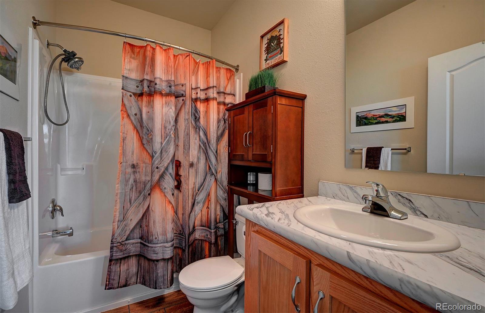 142 Long Rifle Way Como, CO 80432 - Photo 18 of 24 a bathroom with a sink toilet and shower