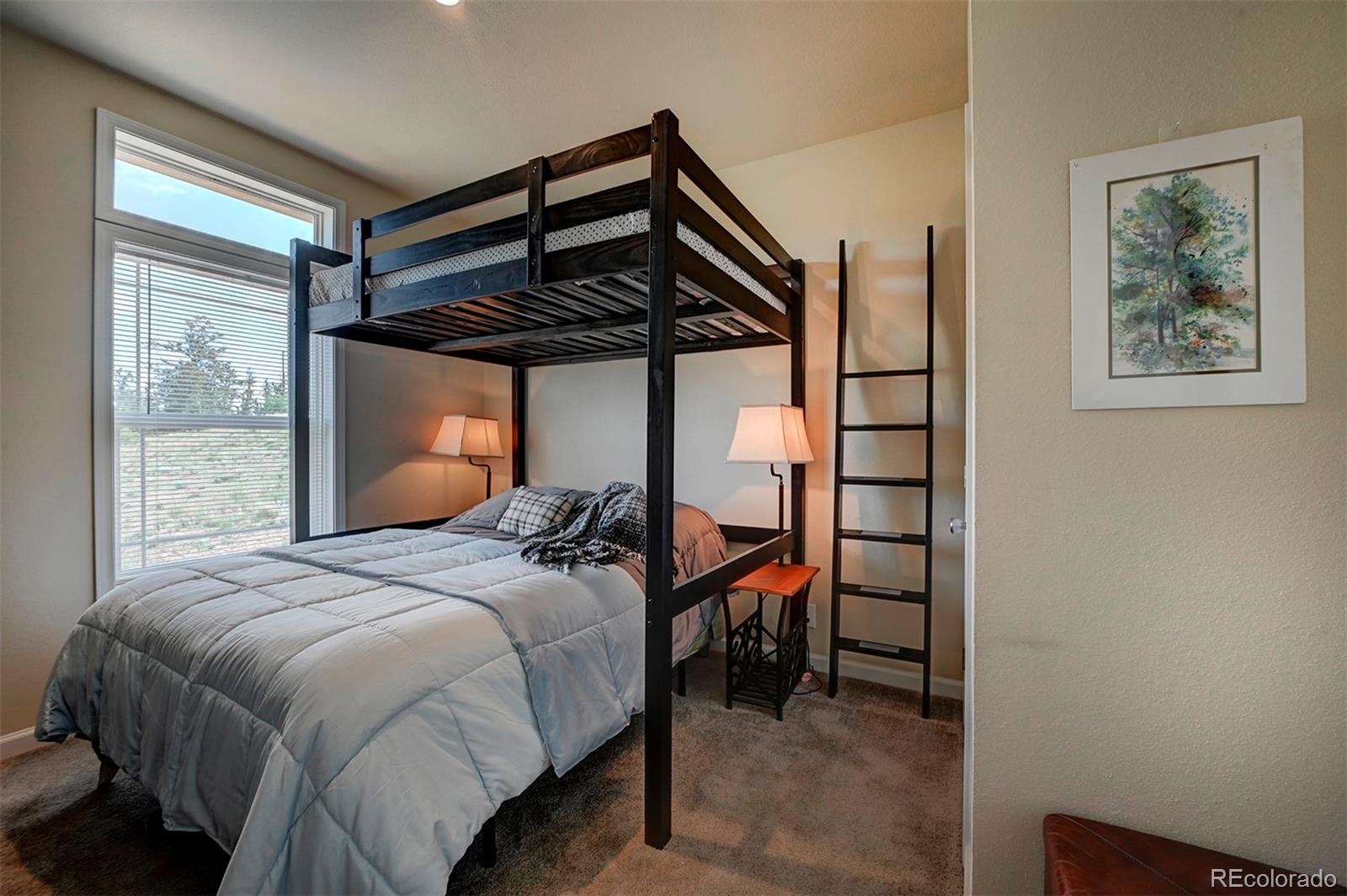 142 Long Rifle Way Como, CO 80432 - Photo 19 of 24 a bedroom with a bed and a window