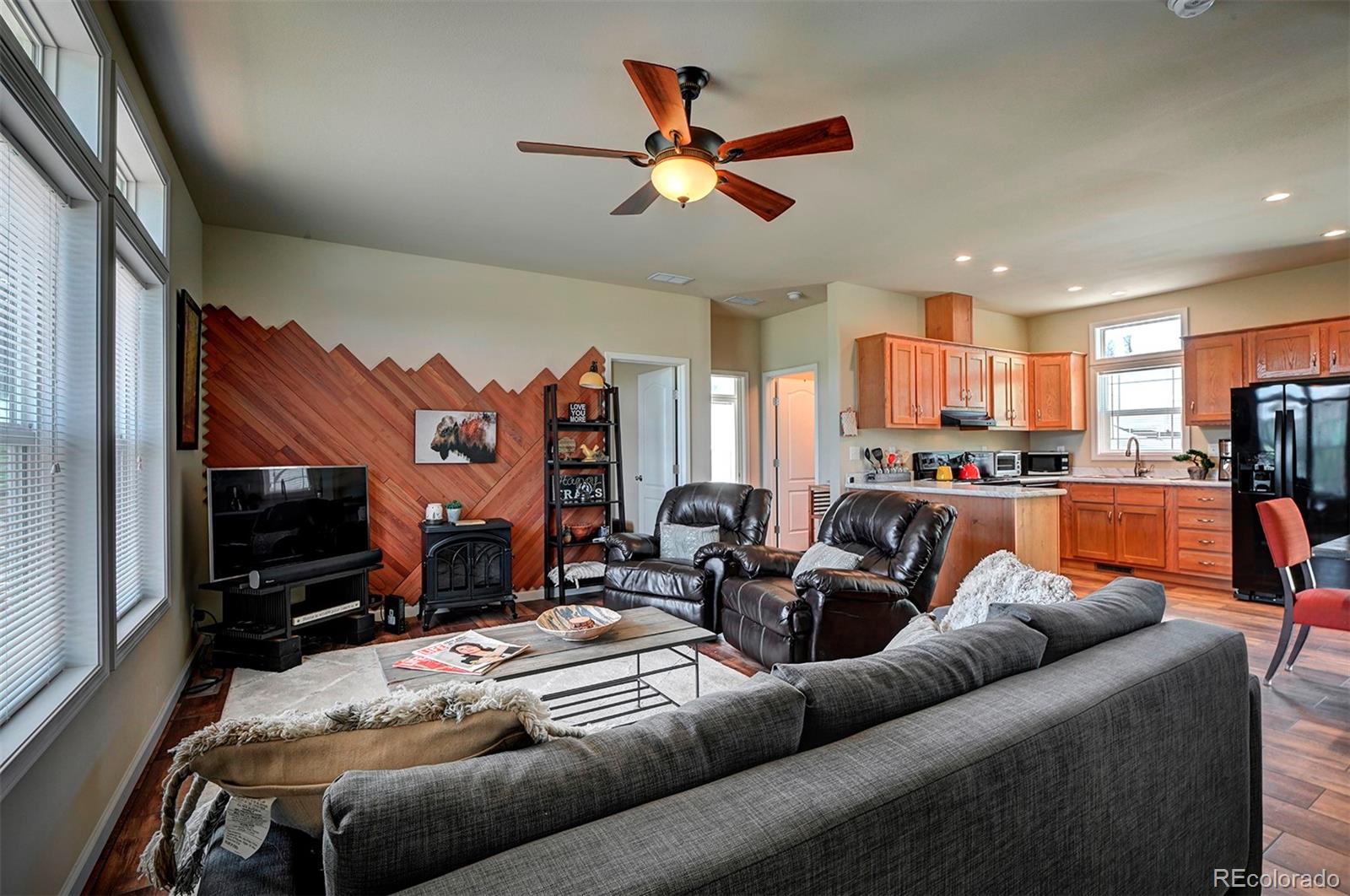 142 Long Rifle Way Como, CO 80432 - Photo 6 of 24 a living room with furniture kitchen view and a flat screen tv