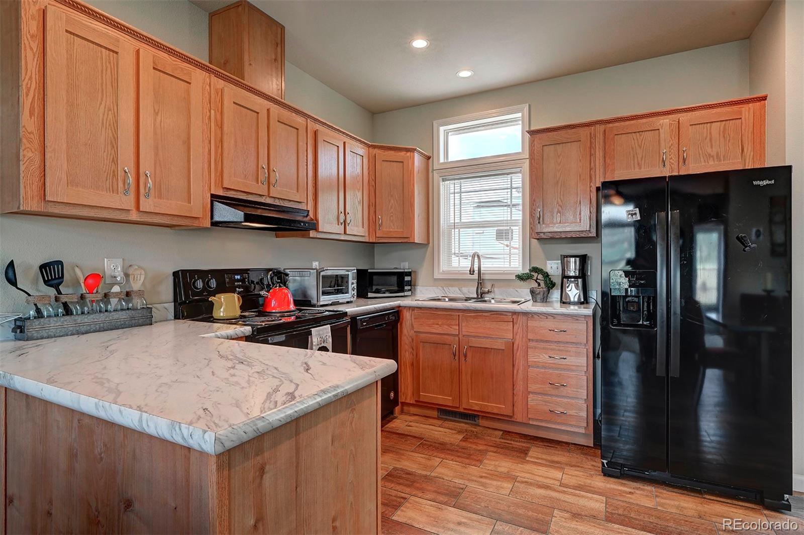 142 Long Rifle Way Como, CO 80432 - Photo 8 of 24 a kitchen with stainless steel appliances granite countertop a refrigerator sink and cabinets
