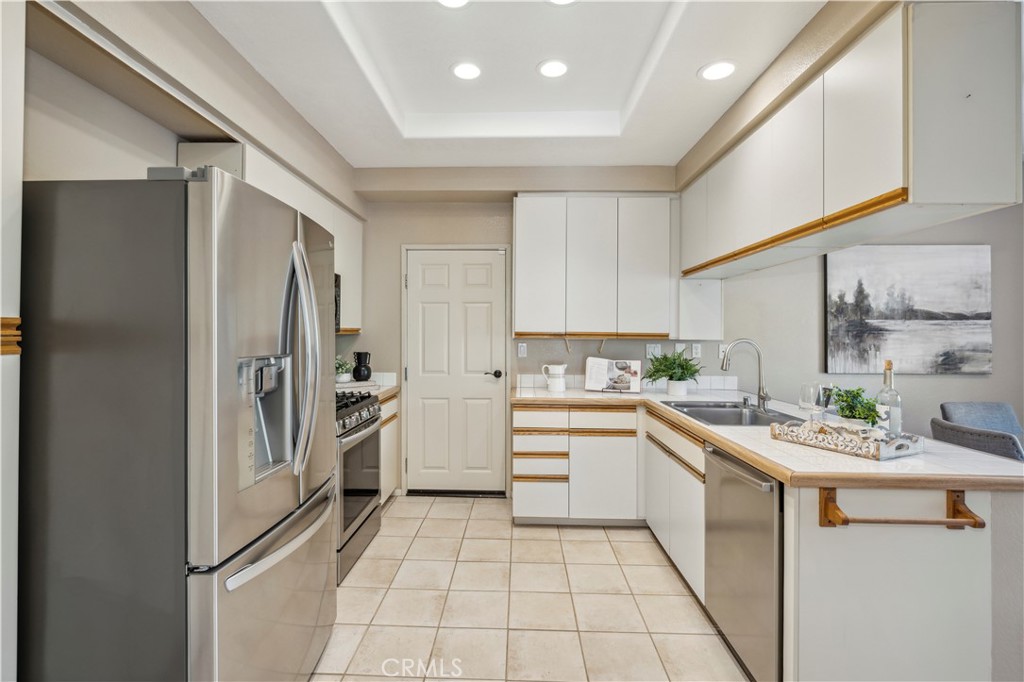 1 Suffolk Downs Laguna Niguel, CA 92677 - Photo 12 of 33 a kitchen with a sink a refrigerator and cabinets