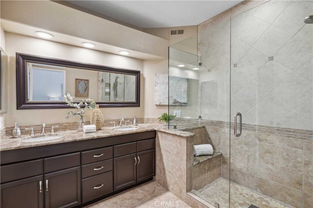1 Suffolk Downs Laguna Niguel, CA 92677 - Photo 20 of 33 a bathroom with a double vanity sink and a mirror