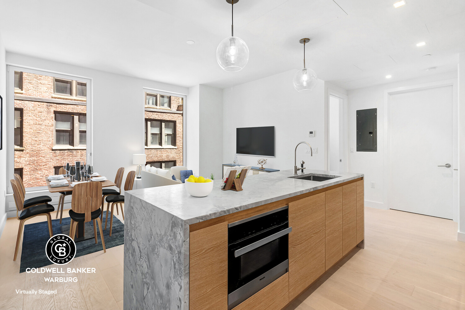215 West 28th Street, Unit 7B Manhattan, NY 10001 - Photo 1 of 7 a view of kitchen island a sink wooden floor and living room view