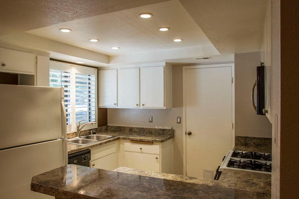 4042 Primavera Road, Unit 12 Santa Barbara, CA 93110 - Photo 5 of 21 a kitchen with a refrigerator and a stove top oven