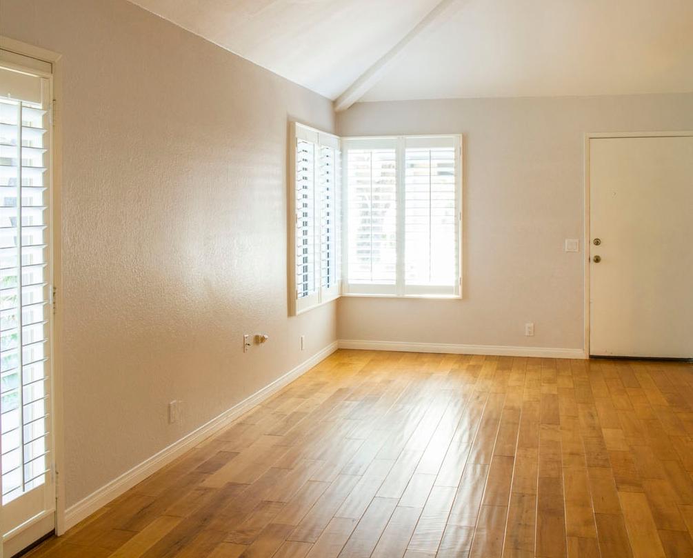 4042 Primavera Road, Unit 12 Santa Barbara, CA 93110 - Photo 9 of 21 an empty room with wooden floor and windows