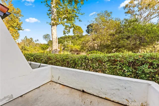 a view of a floor to ceiling window and brick wall