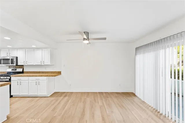 a view of a kitchen with wooden floor