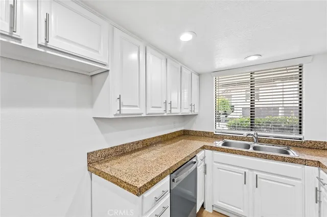 a kitchen with a sink cabinets and window