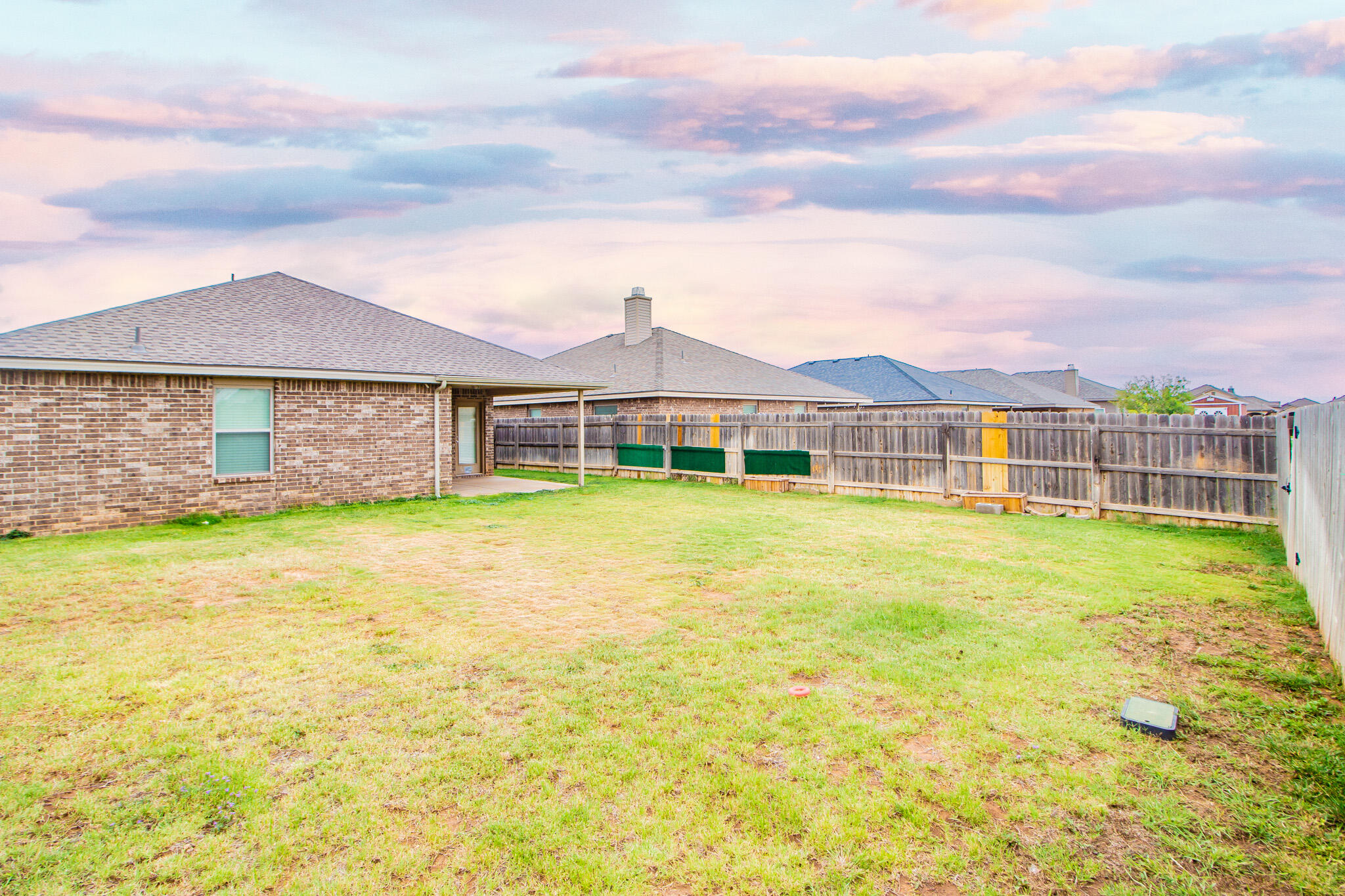 7409 101st Street Lubbock, TX 79424 - Photo 21 of 22 a view of a house with a swimming pool and wooden fence