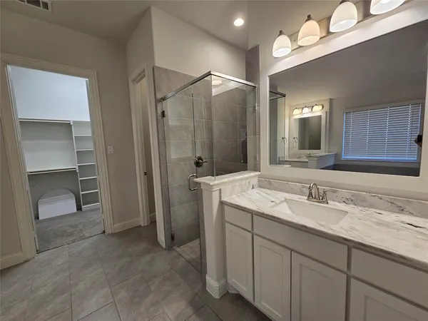 a bathroom with a tub a sink and a window