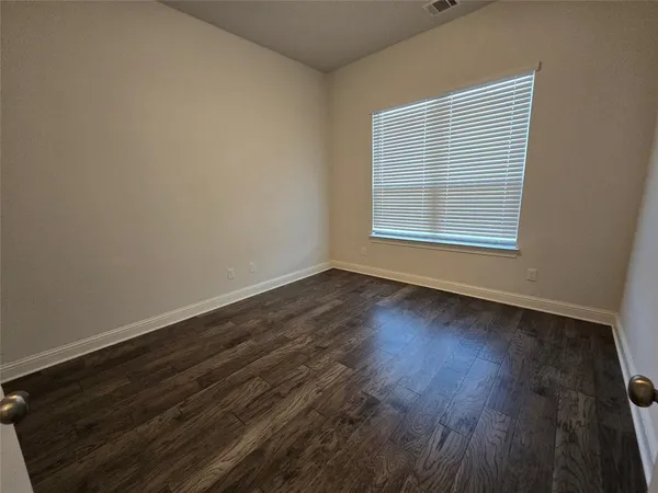 a view of a livingroom with a ceiling fan and window