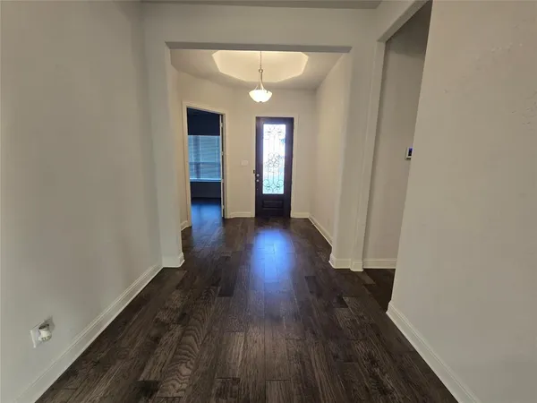 a view of a living room and kitchen with wooden floor
