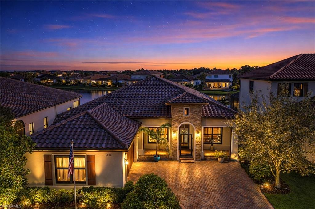a view of a big house with large trees and outdoor space
