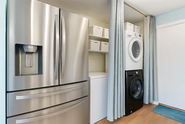 a kitchen with a refrigerator and washer