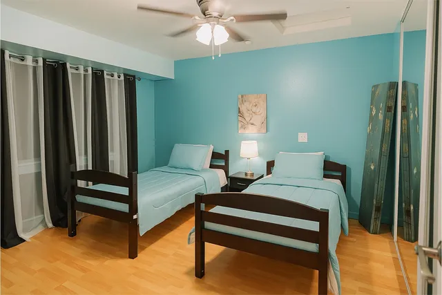 a living room with furniture and large windows