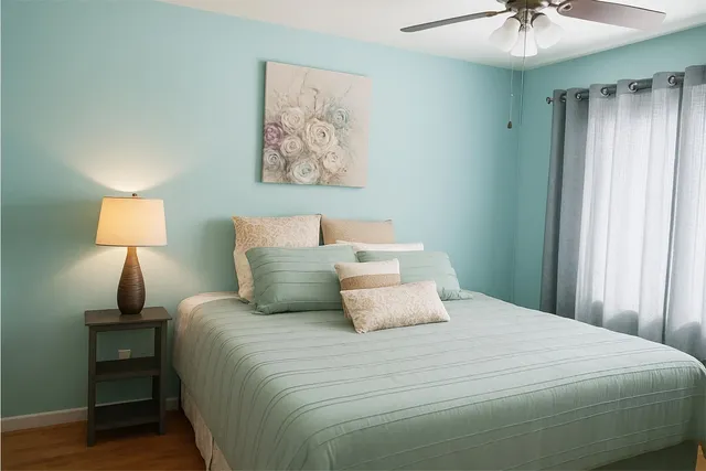 a bedroom with a bed and a chandelier