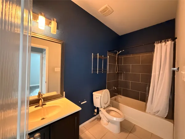 a bathroom with a sink a toilet a mirror and shower
