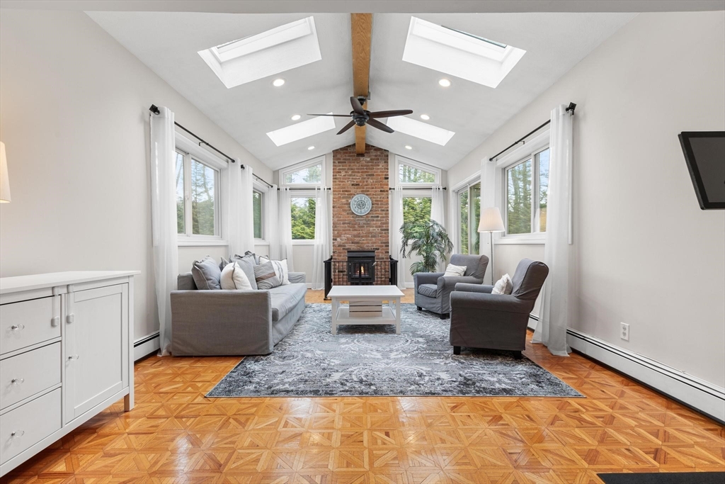 89 Haggetts Pond Road Andover, MA 01810 - Photo 18 of 42 a living room with fireplace furniture and a large window