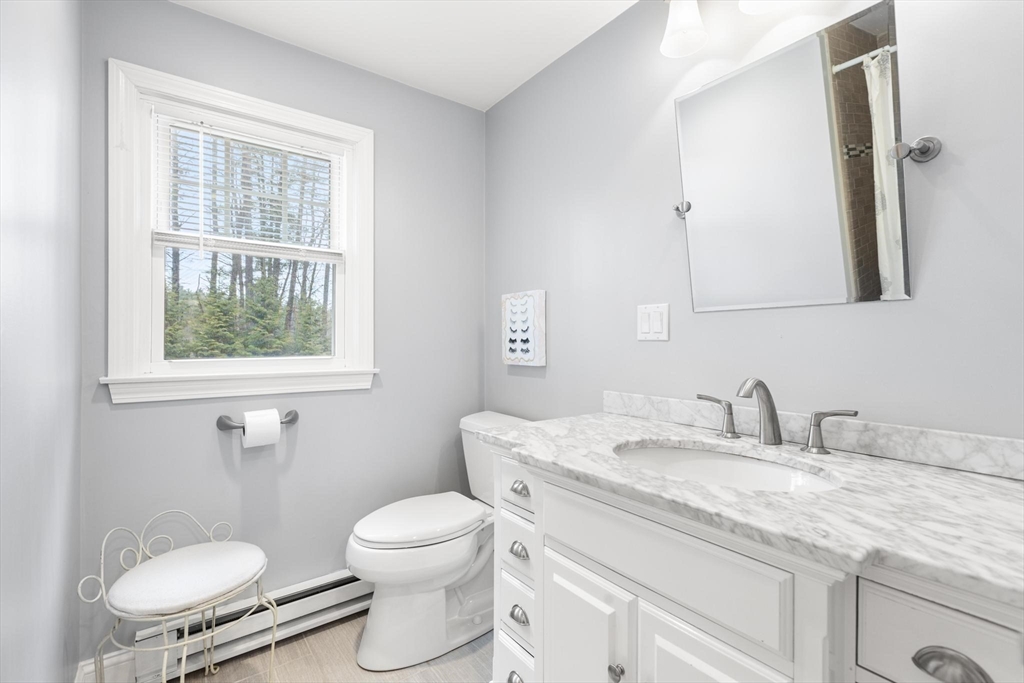89 Haggetts Pond Road Andover, MA 01810 - Photo 21 of 42 a bathroom with a granite countertop toilet sink and mirror