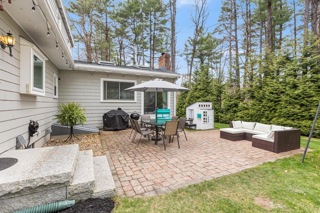 89 Haggetts Pond Road Andover, MA 01810 - Photo 3 of 42 a view of a patio with couches table and chairs potted plants and large tree